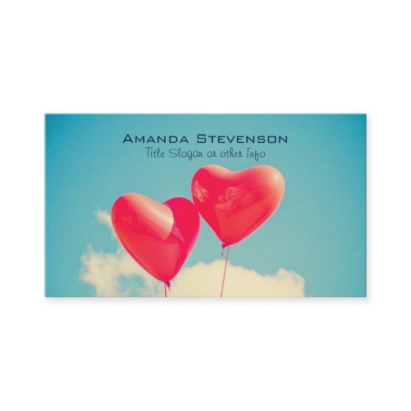 2 Bright Red Heart Shaped balloons Floating Upward