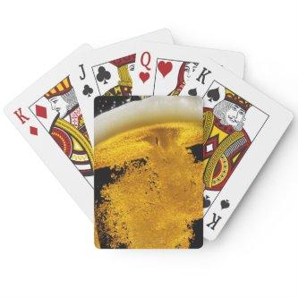 Beer been poured into glass poker cards