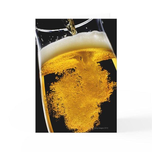 Beer been poured into glass, studio shot card