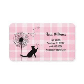 Black cat with dandelion on plaid