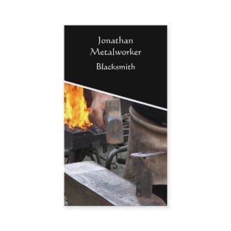 Blacksmith hammering hot iron
