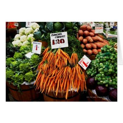 Bunches of carrots and vegetables on market