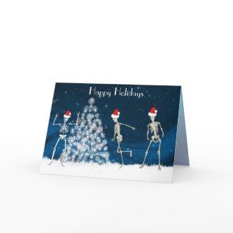 Christmas cavorting skeletons on blue holiday card