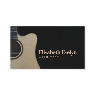 Closeup of cutaway acoustic guitar over black