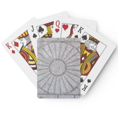 Concrete with a sun carved on it poker cards