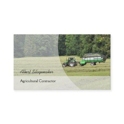 Green tractor with a silage laden trailer