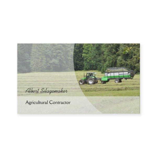 Green tractor with a silage laden trailer