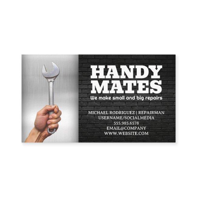 Hand Holding Wrench | Metal and Brick
