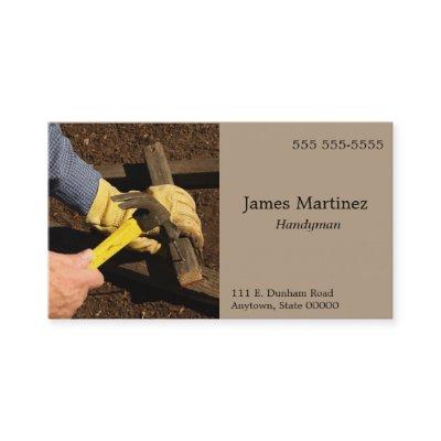 Man hammers wood piece