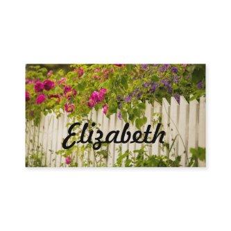 Personalized pink roses on a white garden fence