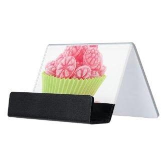 Raspberry tasty candy sweets in green cup cake desk  holder