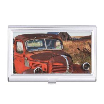 Rusting orange Dodge truck with abandoned farm Case For