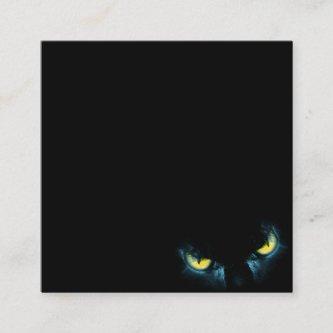 Scary cat eyes on a black background square