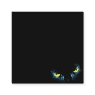 Scary cat eyes on a black background square