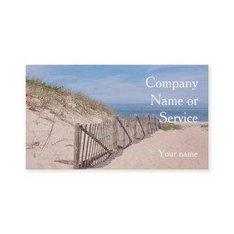 Seashore scene with beach fence and sand dune