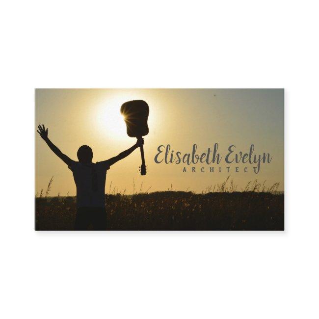 Silhouette of Man Holding Guitar on Plant Fields