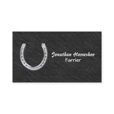 Silver horseshoe on black denim