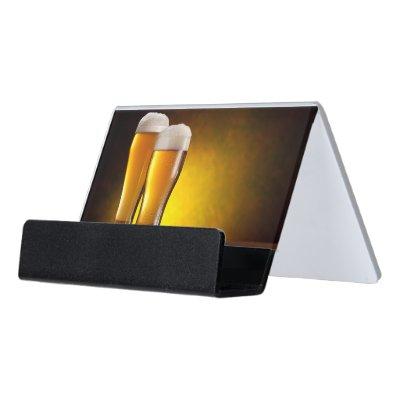 Two glasses of beers on a wooden table desk  holder