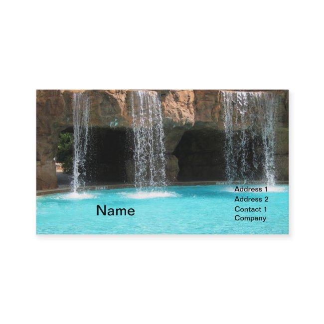 wate cascading by an outdoor cave and pool